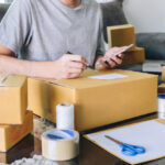 young-entrepreneur-sme-freelance-receive-order-client-take-note-working-with-packaging-sort-box-delivery-online-market-purchase-order_28283-985